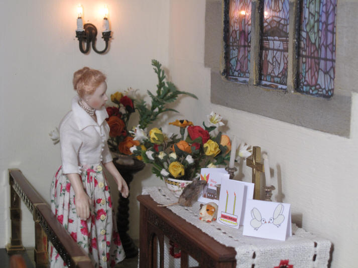Esther, who has arranged all of the church flowers for this Pentecost celebration, is inspecting them to make sure everything is in good order for the service..........
