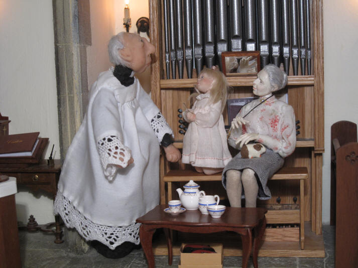Priscilla Jane tells the vicar that she has found the teaspoon and is showing it off to him!