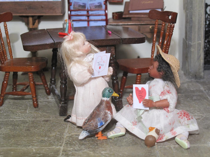 Gracie and Priscilla Jane show off their now finished Valentine's Day cards to each other...
